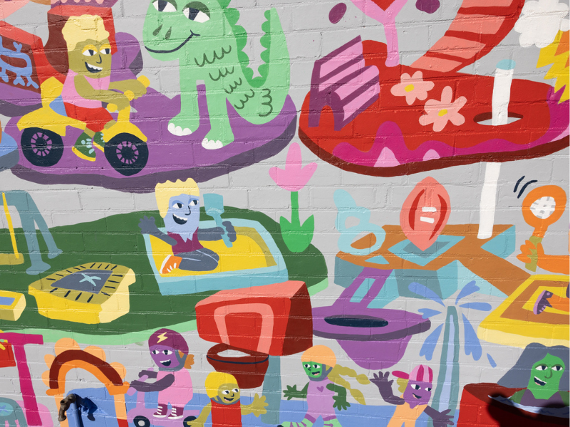 Albury World mural on brick wall with many colorful creatures.