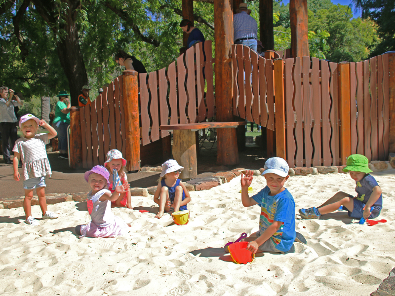 Several small children playing in a sandbox in Albury