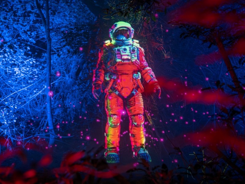 Astronaut image built from light floating in night scene