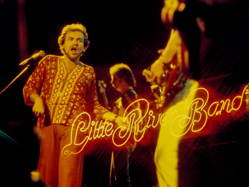 Little River band on stage performing in Melbourne 1977, logo displayed over photo