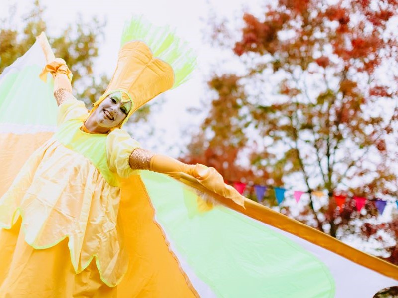 Woman in yellow costume smiling at camera