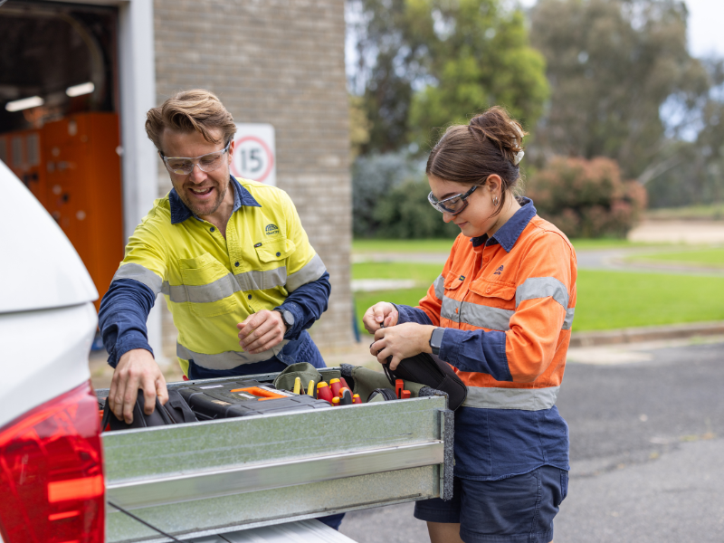 Two Council workers pictured with equipment and vehicle